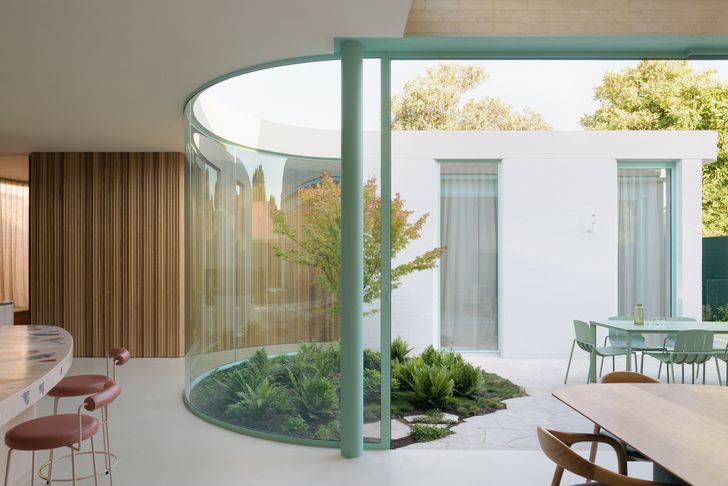 The atrium separates and connects the home's public and private zones.