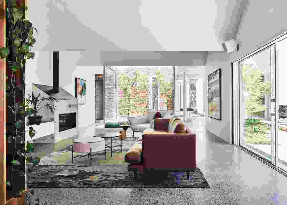 The central living area is filled with light and surrounded by garden. Artwork: Anna Cole (left) and Katie Wyatt (right).