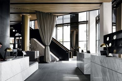 The monolithic welcome desks and grand staircase in the double-height entry space make a grand first impression.