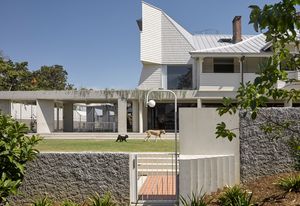 The delicate timber structure of the old Queenslander house has been rotated 90 degrees and raised onto concrete stumps.