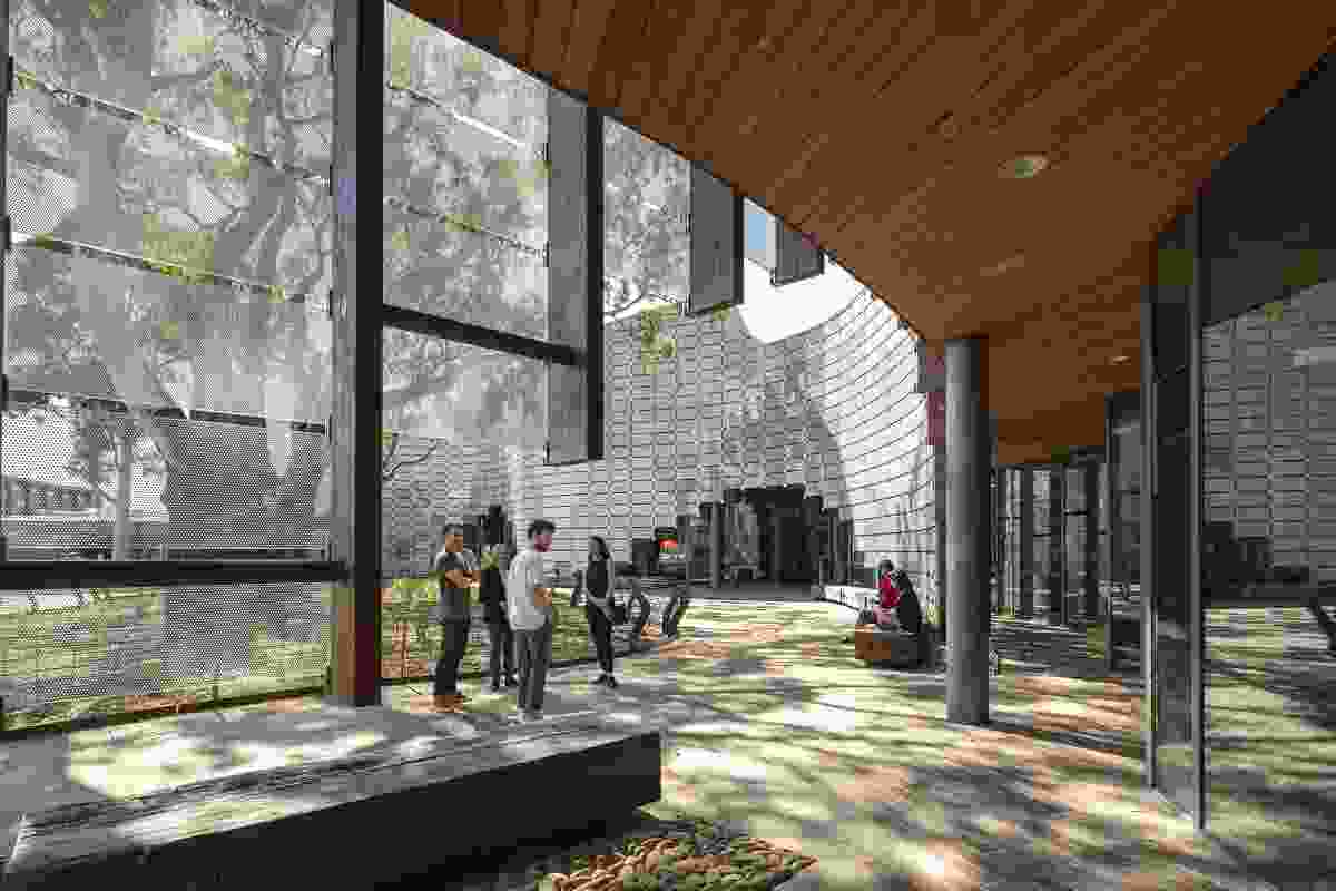 Around the river red gums the brick-scape flows into the building and library balconies look out into the trees.