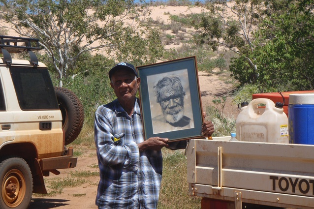 Frank Sebastian holding a photo of Friday Walmadany (Franks uncle) who was an important law man that lived at James Price Point area early 20th century.