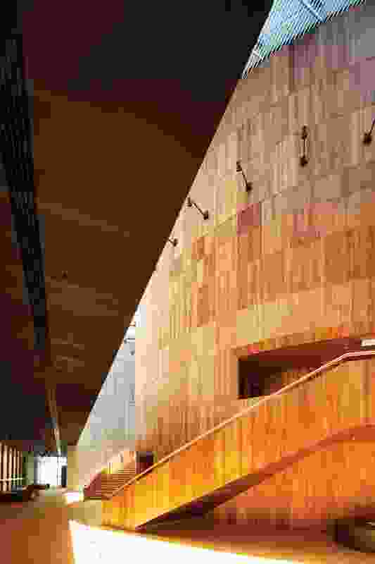 Twin stairs curve around the timber-clad drum that houses the main theatre.
