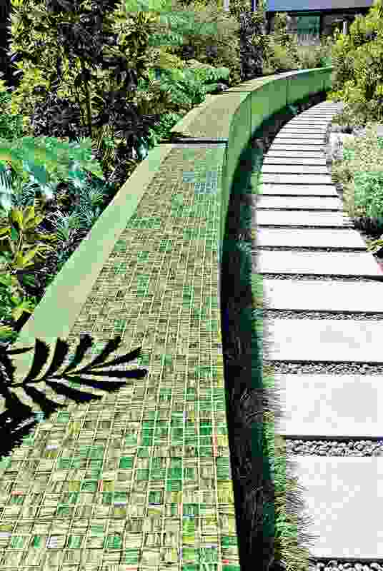 A green mosaic wall forms a strong muscular element in the rear of the Adelaide villa garden.