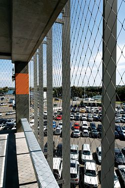 The single tensioned cable mesh fabric facade allows “open deck” classification for the Sydney International Airport car park, by DesignInc. Image: Martin Van der Wal.