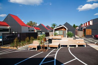 The barbecue is a meeting point in the shared outdoor space.