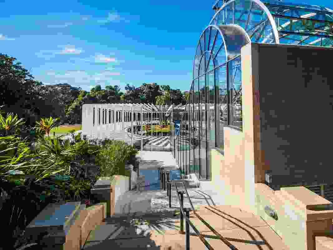 The new Calyx structure designed by PTW Architects and McGregor Coxall in the Royal Botanic Gardens Sydney is set next to the Arc glasshouse designed by Ken Woolley.