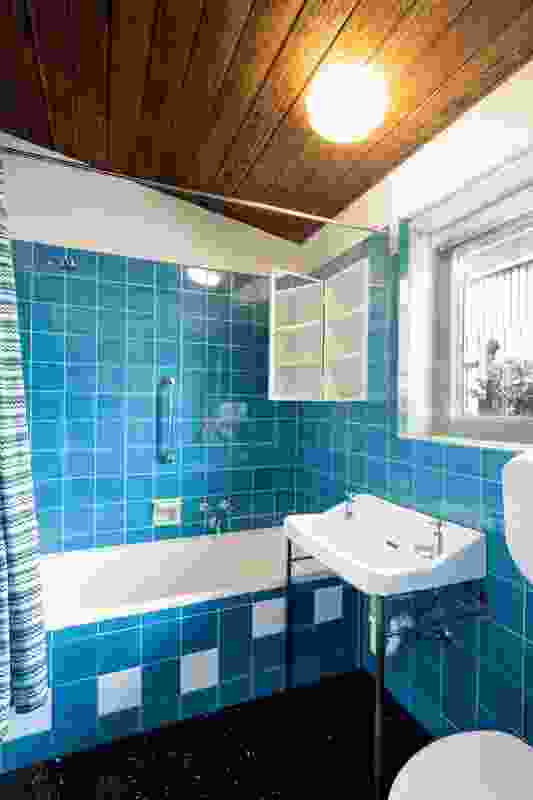 Classic 1950s-era tiling and tapware have been retained in the kitchen and bathrooms.