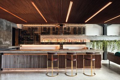 In the open-air cocktail bar, timber screens the overhead soffit and bar front, while marble counter- tops and brass-lined stools speak of influences from New York and Miami.