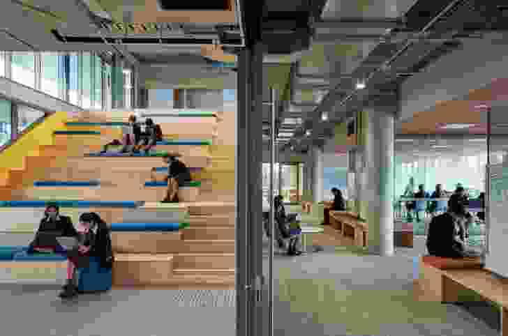 Double-height volumes of stepped bleacher seating link clusters of flexible learning spaces.