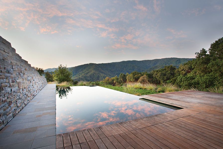 Low-level textural plantings and the reflective surface of the infinity pool enhance the outstanding borrowed views at Halls Ridge, Carmel Valley, California.