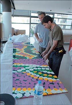 Installing Tommy Watson’s  Wipu Rockhole on the third floor ceiling. Image: Philippe Ruault