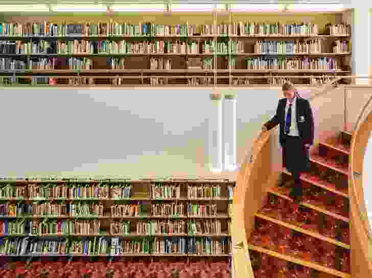 The library rooms are comprised of two-storey volumes connected by sweeping staircases.