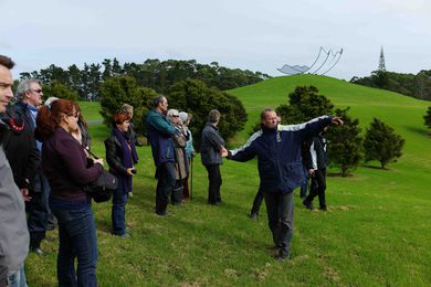 The author explains the lie of the land during a NZILA Auckland Branch visit to Gibbs Farm. On yonder hill is Neil Dawson’s 'Horizons' (1994).
