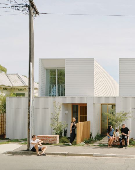 Brick seats, shared gardens and the absence of fences allow the street edge to feel semi-public at Northcote Townhouses by Birthisel Wittingslow Architects, Studio Esteta and Carr.