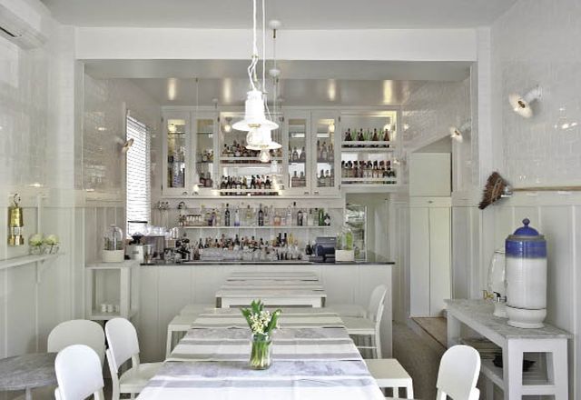 The downstairs kitchen is casual in all white.