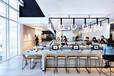 The design of the sushi train was inspired by subway stations. it features subway tiles and glowing led rings that are reminiscent of train handles.