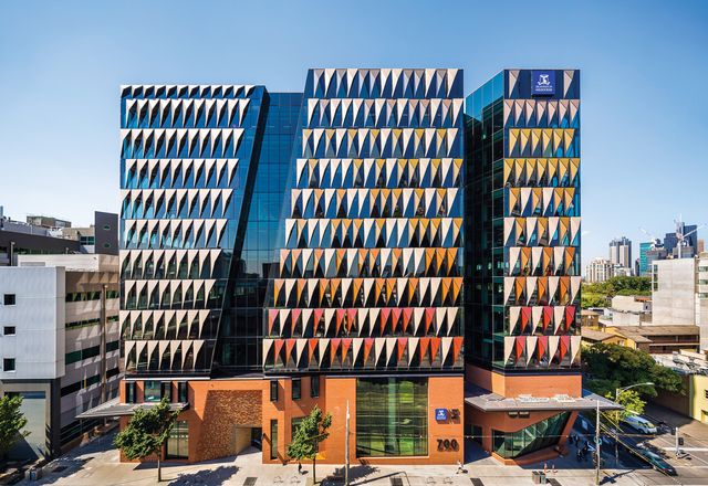 The prism-shaped panels on the main tower facade respond to environmental conditions and form part of the precinct’s comprehensive sustainability strategy.