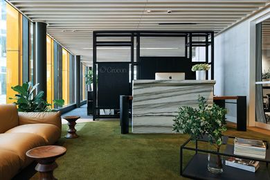 The custom-designed joinery behind the reception desk divides the lounge area from workspaces.