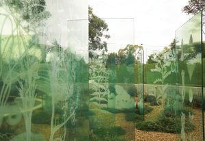 A formal grid of glass panels acts as both veils and screens in the garden, presenting and preserving memories.