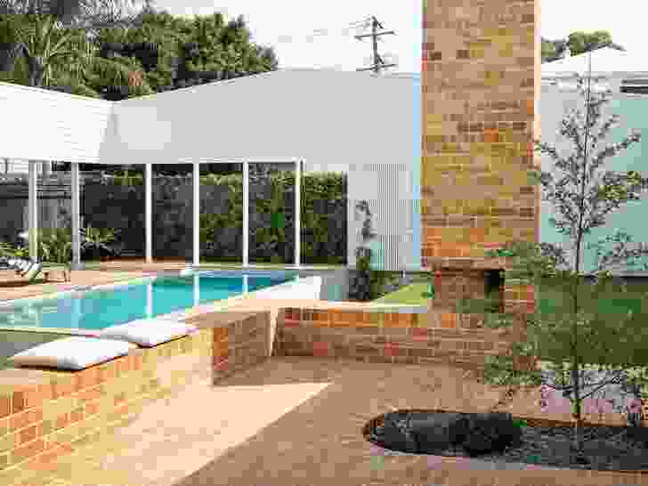 Beyond the court, a “ha-ha” ditch mitigates the need for pool fencing, enabling sight lines across the backyard.