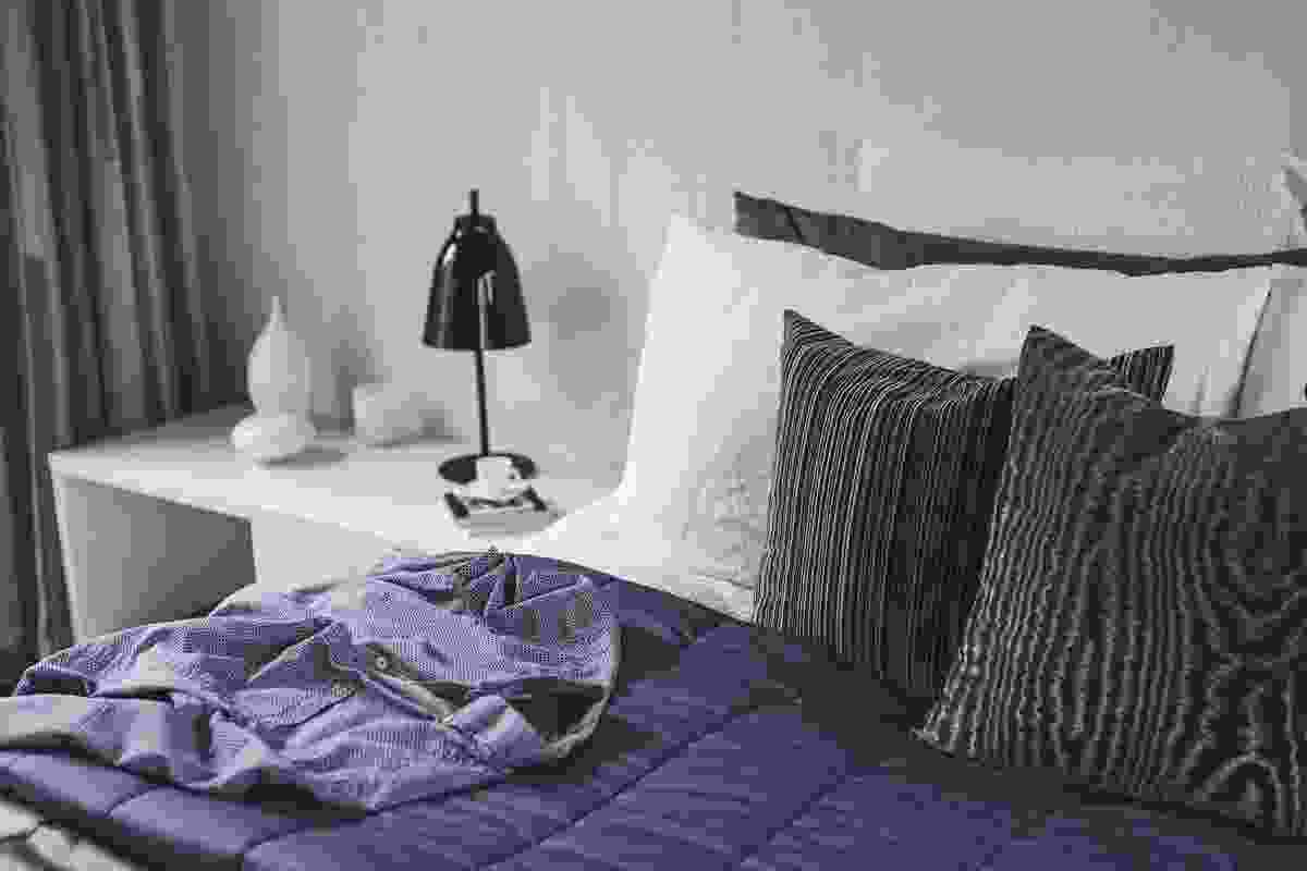 A purple bedspread in the bedroom is chosen to complement the homeowner's wardrobe. 