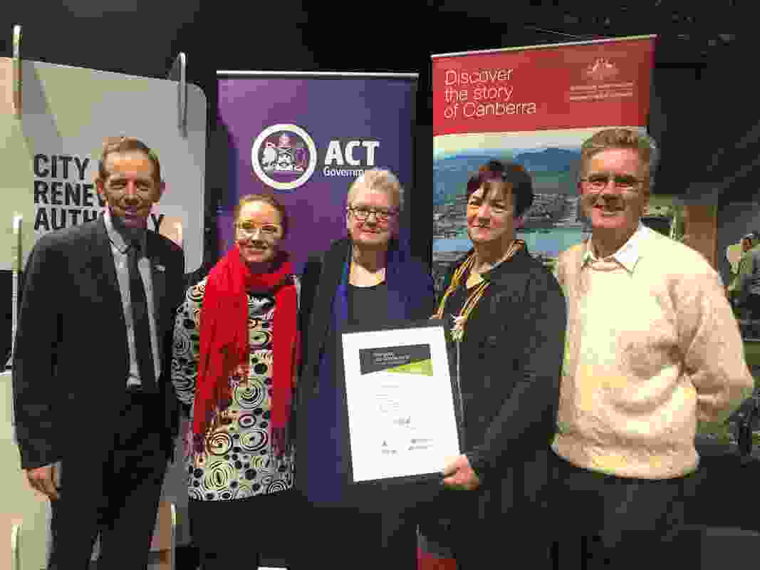 ACT Minister for Climate Change and Sustainability, Shane Rattenbury, presents the ‘Stomping Grounds’ with their award.
