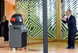 Gombe-san performing at Australia House opening with Karaoke robot.