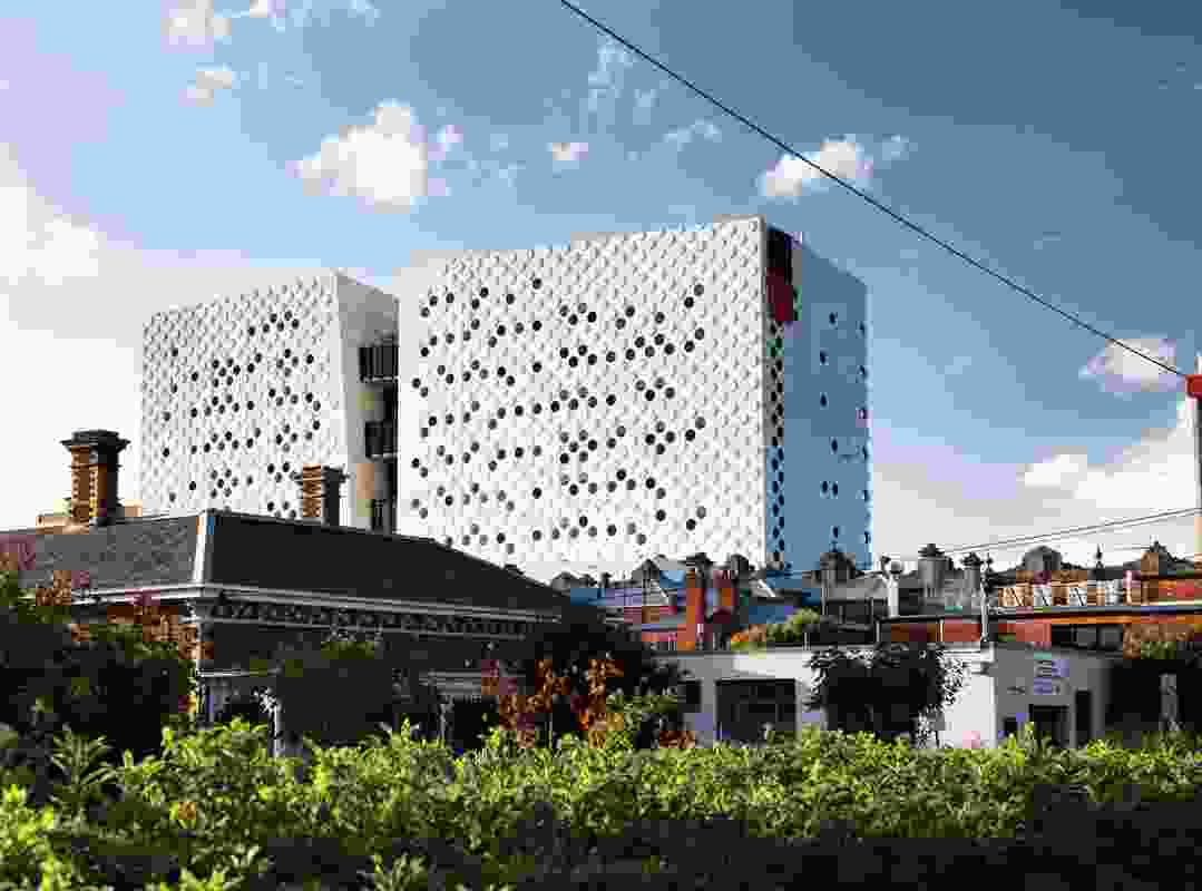 The pattern of circles on the facade strengthens the buildings’ appearance from a distance.