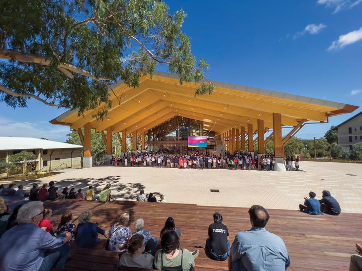 In the northern events space, the timber beams span 30 metres, creating an open, shaded space for the university and the community.