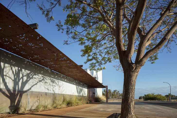 Laser-cut steel canopies by Spinifex Hill artist Ann Sibosado are installed along the entrance to the gallery.