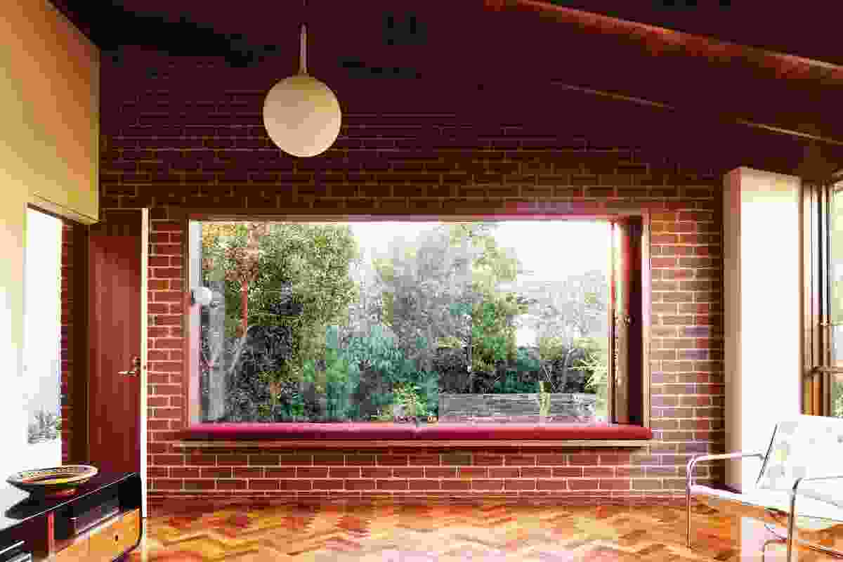 A large window frames the Australian indigenous garden.
