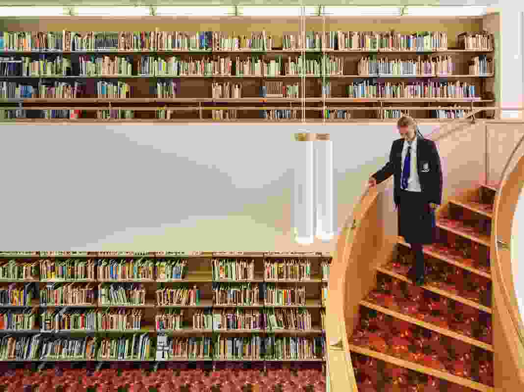 The library rooms are comprised of two-storey volumes connected by sweeping staircases.