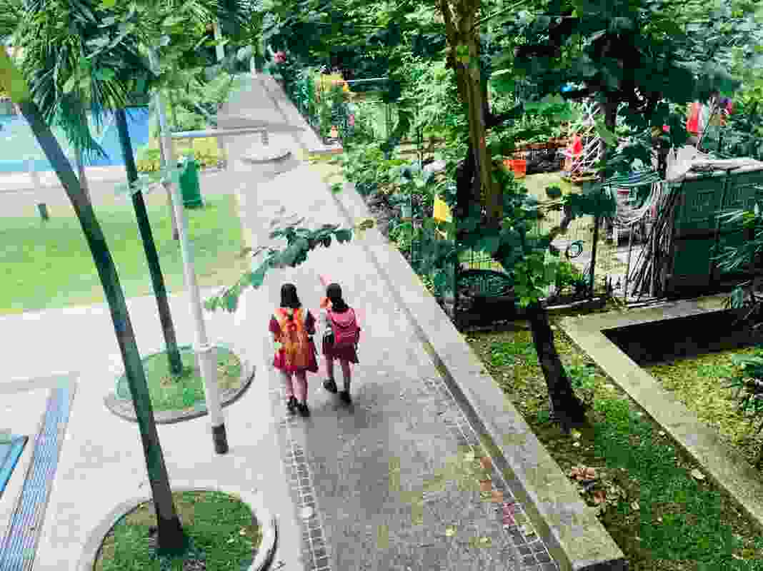 Children in Singapore, walking to school through the neighbourhood community gardens.