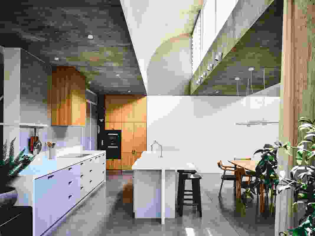 A wave-like concrete roof profile creates interest while allowing sunlight into the kitchen and living area. 