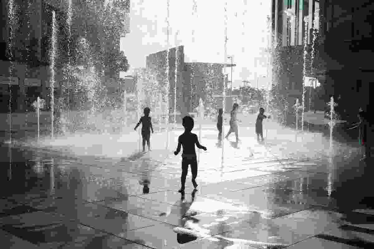 Children playing in fountains during the summer.
