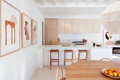The kitchen is central to the home’s spatial configuration. Artworks: Bobby Clark (left wall), Ash Holmes (back wall).