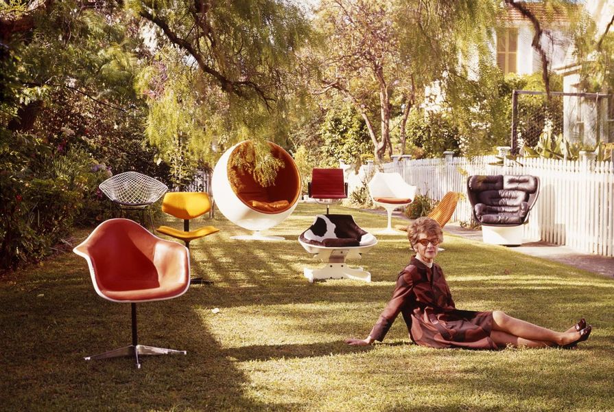 Marion Hall Best sitting on lawn with nine chairs by designers Andrews, Arnio, Saarinen, Colombo, Eames and Bertoia at The Grove, Woollhara.