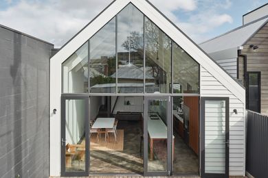 Double-height glazing at the house’s southern end lets in ample light. The house extends onto a small but useful courtyard.