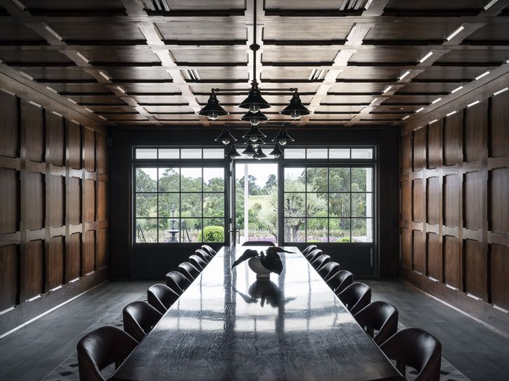 A private 20-seater dining room is entirely clad in blackbutt and sealed Oregon wall panels, stained by hand.