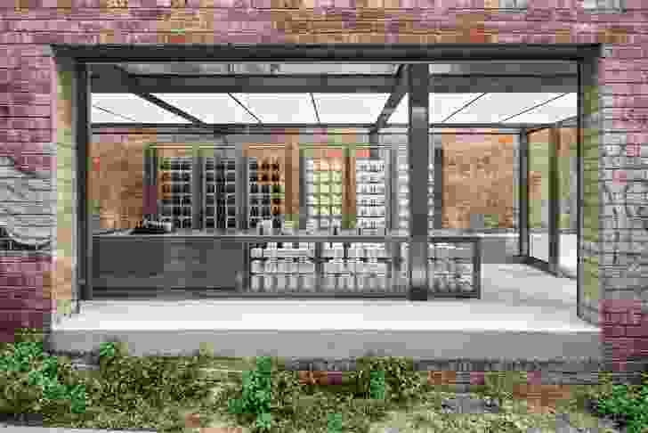 The journey to the store’s entrance at the rear of the terrace house allows glimpses into the retail space through openings in the old brickwork.