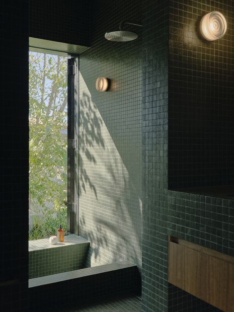 Green tones and generous openings in the ensuite respond to a client brief for an immersive experience of garden.