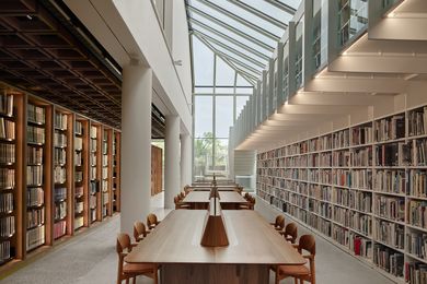 The bright atrium of the Joanna Capon Reading Room is revived by a reglazed roof and vertical wall, a new polished concrete slab, spotted gum bookshelves, and matching timber and leather furniture.