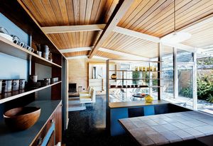The single gable roof and expansive plate glass windows make for breezy interiors befitting a coastal location.