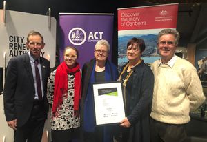 ACT Minister for Climate Change and Sustainability, Shane Rattenbury, presents the ‘Stomping Grounds’ with their award.
