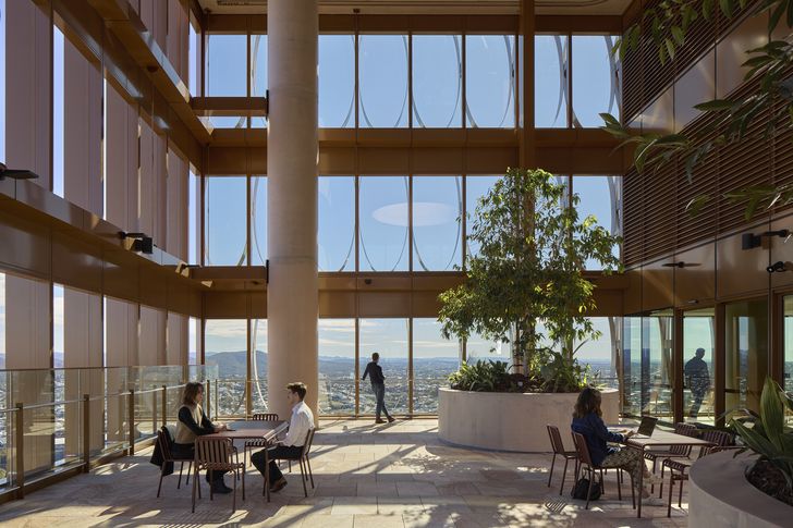 Landscaped outdoor terraces ascend the tower, creating third spaces for breaks and meetings.