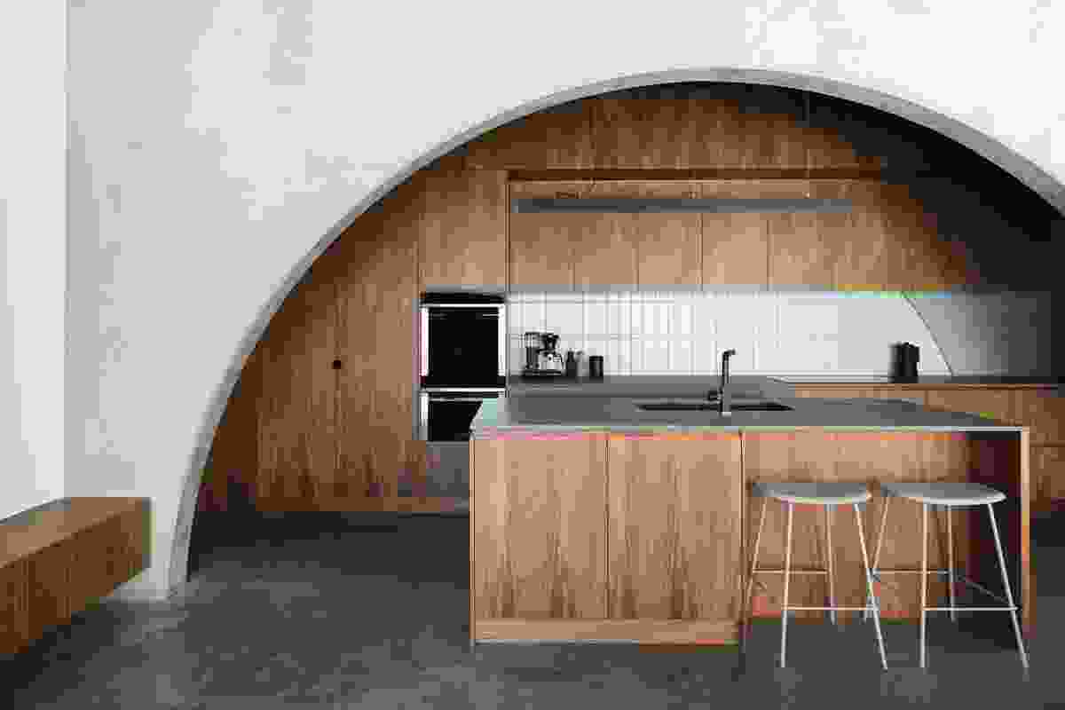 The heaviness of the concrete building is offset by the form of the arches and the timber joinery.