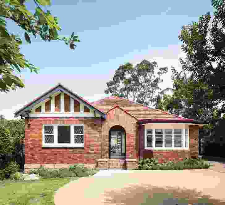 The original home was built in the 1930s and features Tudor detailing, leadlight windows and an intricate brick arch over the porch.