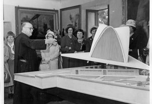 Fr Mauro Enjuanes showing the model of the cathedral to a group of local residents, c. 1959. Accession number 74893P.