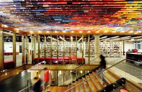 At QUT Kelvin Grove Library, a ceiling made of hundreds of old book covers adds drama to the staircase.